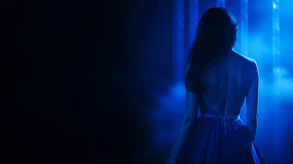 Belly OnlyFans creators — woman in a fitted evening dress in neon rim light, a jeweled belly chain catching the light