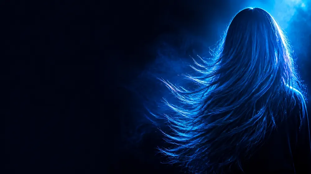 Redhead OnlyFans creators — long flowing hair catching bright blue rim light, copper glints in the flowing hair